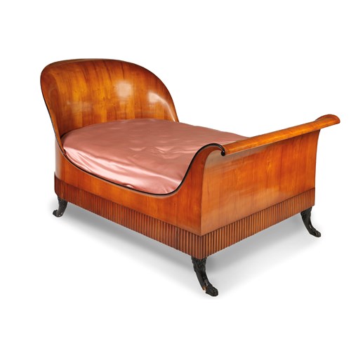 An Italian Neoclassical carved, veneered and ebonized cherry wood bed